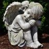 Garden angel 34cm, sitting crouched child, grey-green patina