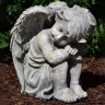 Garden angel 24cm, sitting, head right, grey-green patina