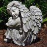 Garden angel 24cm sitting, head left, grey-green patina