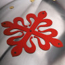 Metal shield with red Calatrava Cross
