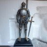 Renaissance knight in a gilded armor, figure - broken sword