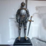 Renaissance knight in a gilded armor, figure - broken sword