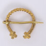 Notched brass fibula with crosses at ends