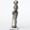 Tin knight statue in gilded armor with besagews